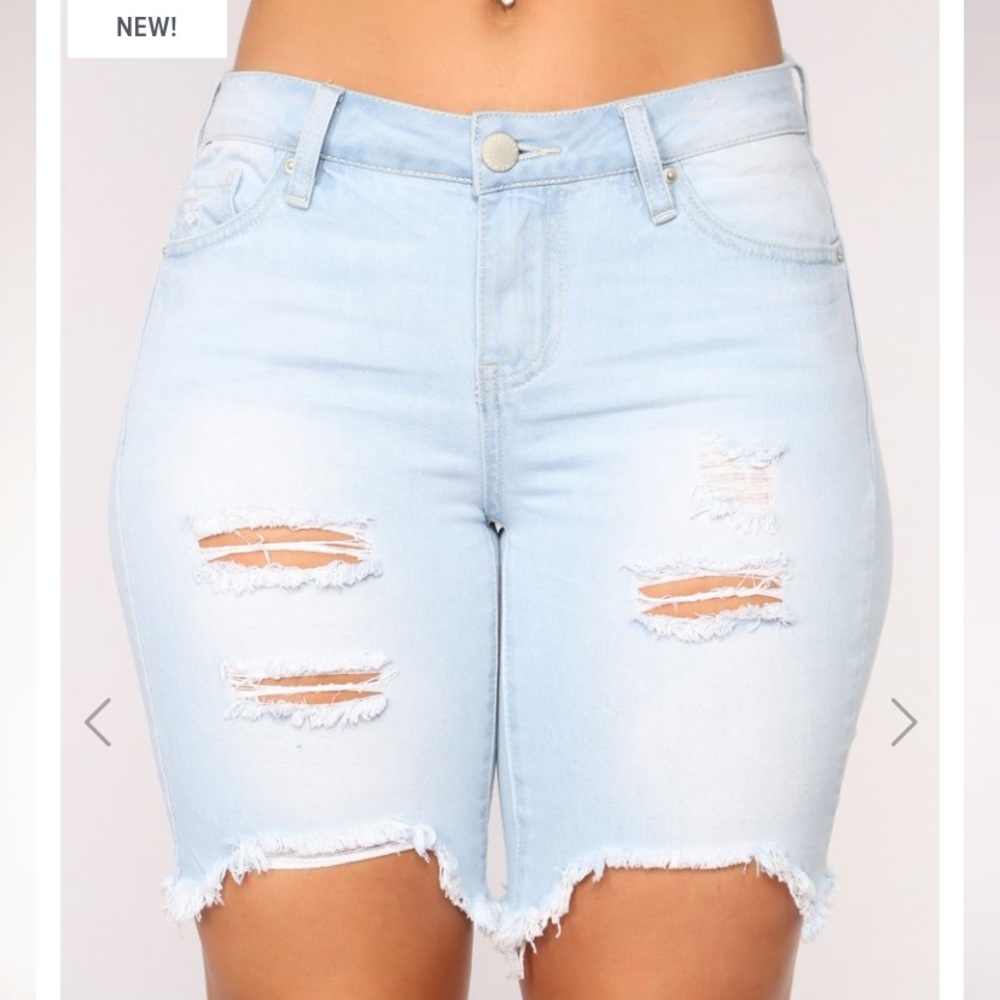 Mid rise light wash distressed Bermuda jean shorts